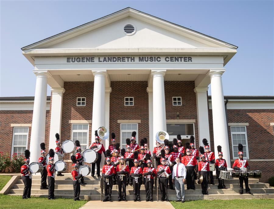   The ASB band on the steps of the Landreth Music Center wearing their uniforms with their director.